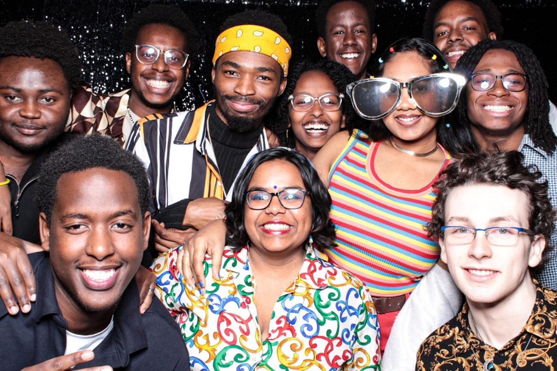 An orange sign on a metal locker reads Bike Lockers