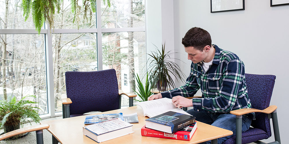 A student with books spread out in front of them.