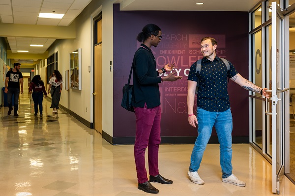 Students in hallway outside of Arts Commons, second floor of the McNally Building